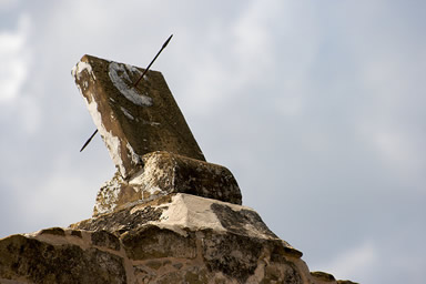 Stone sundial atop the gate