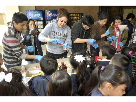 Santa Ana College science students demonstrate various chemical reactions for kindergartners during the annual KinderCaminata event at the college on Friday morning.