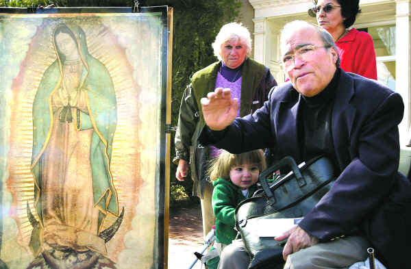 <p>Henry Casso speaks to a crowd in 2001 during a demonstration to oppose a digital print of Our Lady of Guadalupe pictured in a nontraditional costume fashioned from pink, white and yellow roses that was part of an exhibit at the Museum of International Folk Art. Casso died Tuesday in Albuquerque. He was 82. New Mexican file photo</p>