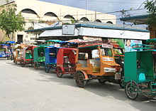 https://en.wikipedia.org/wiki/File:Motor_tricycles_for_hire_lined_up_outside_public_market_in_downtown_Bantayan.JPG