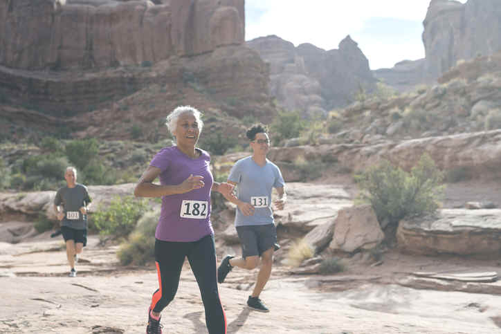 Senior woman running in race